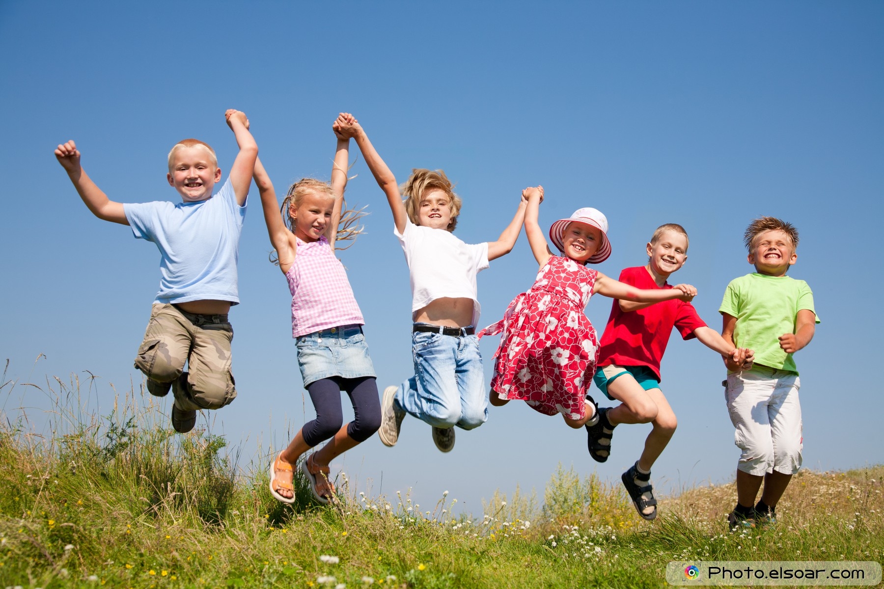 Group-happy-children-jumping-on-summer-meadow